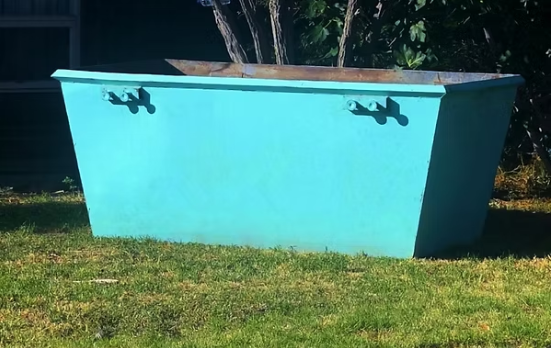 3 cubic meter turquoise skip bin hire Adelaide - small waste bin on residential lawn for garden jobs and small renovations